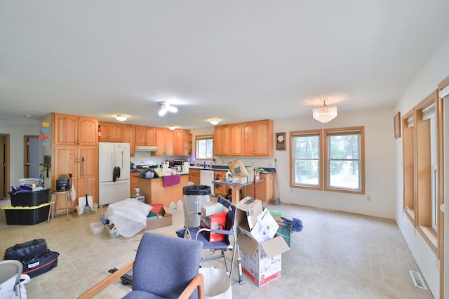 21682 Rebel Rd, Center Twp, MN 56465 - kitchen featuring white appliances, under cabinet range hood, and a center island