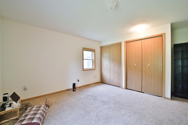 21682 Rebel Rd, Center Twp, MN 56465 - unfurnished bedroom featuring two closets and carpet flooring