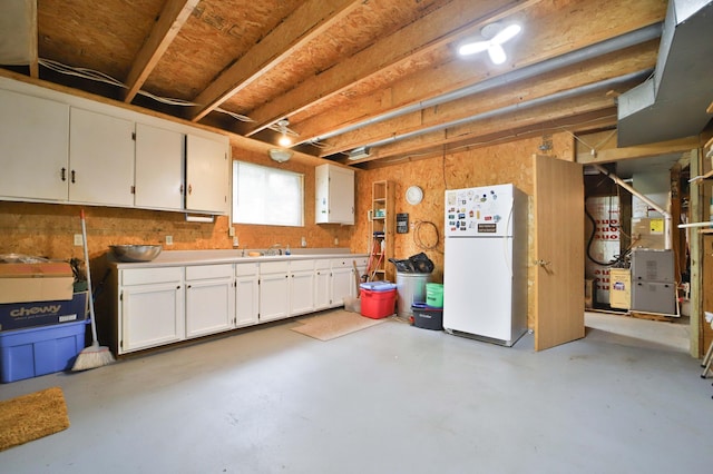 21682 Rebel Rd, Center Twp, MN 56465 - below grade area featuring freestanding refrigerator and heating unit