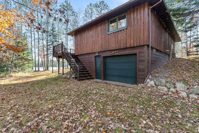 view of property exterior featuring stairs and a wooden deck