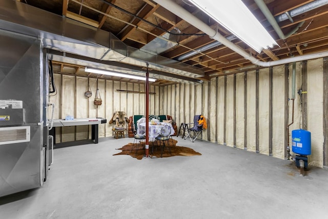 unfinished basement featuring heating unit