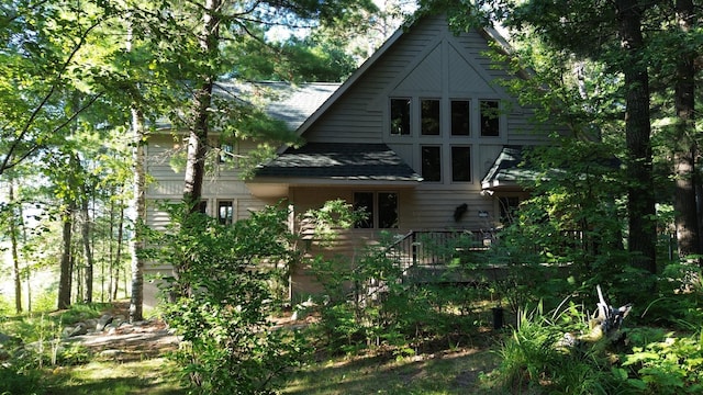 back of property featuring a shingled roof