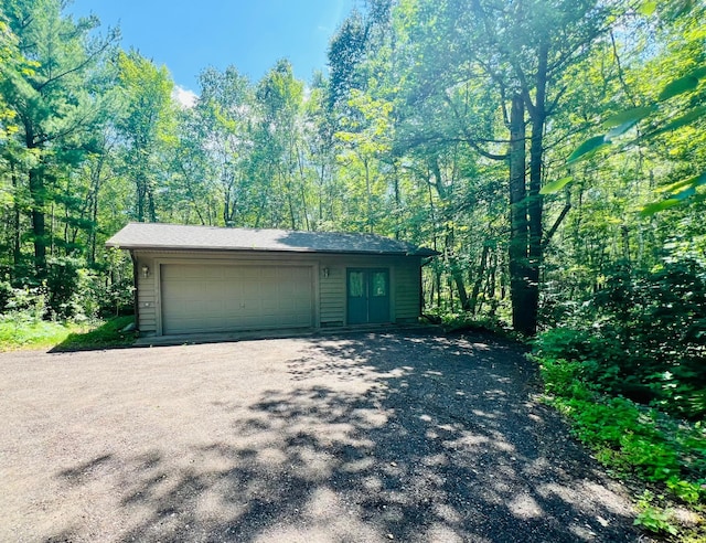 garage featuring a wooded view