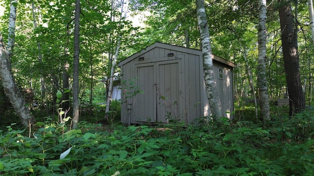 view of shed with a view of trees