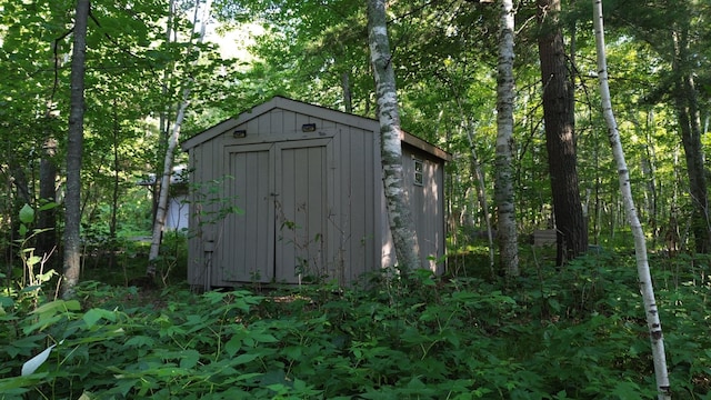 view of shed featuring a forest view