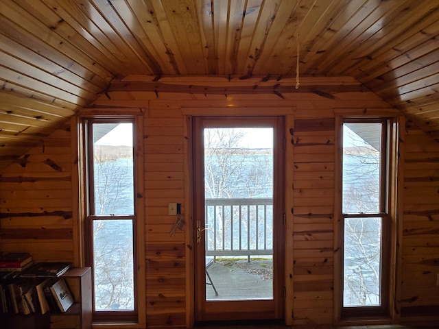 doorway featuring wood walls, wooden ceiling, and vaulted ceiling