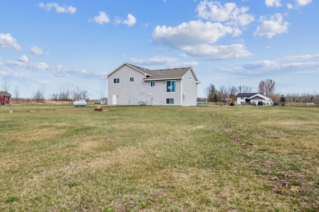 rear view of property featuring a yard