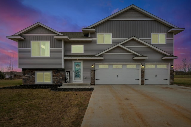 view of front of home featuring an attached garage, stone siding, and driveway