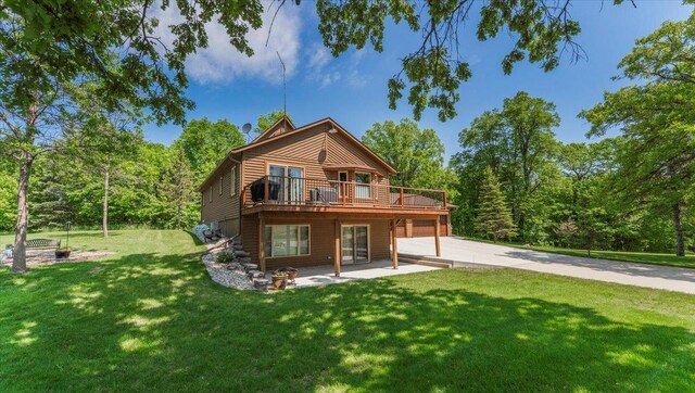 12468 Hermosa Beach Rd NW, Alexandria, MN 56308 - rear view of house featuring concrete driveway, a lawn, a deck, and a patio area