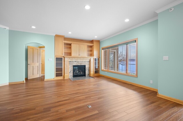 200 Michigan St Unit 1, Lake City, MN 55041 - unfurnished living room featuring baseboards, crown molding, wood finished floors, and a premium fireplace