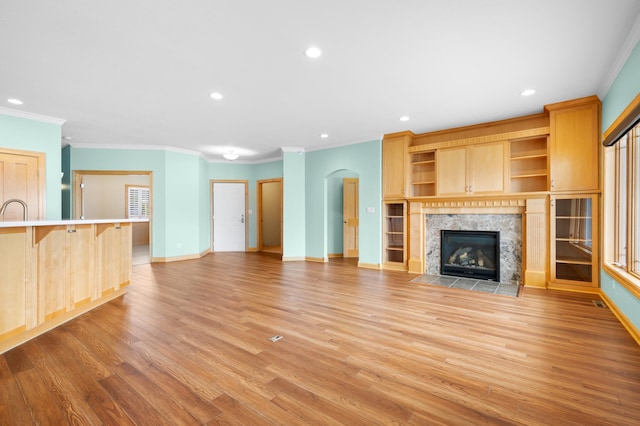 200 Michigan St Unit 1, Lake City, MN 55041 - unfurnished living room featuring recessed lighting, light wood finished floors, a premium fireplace, crown molding, and baseboards
