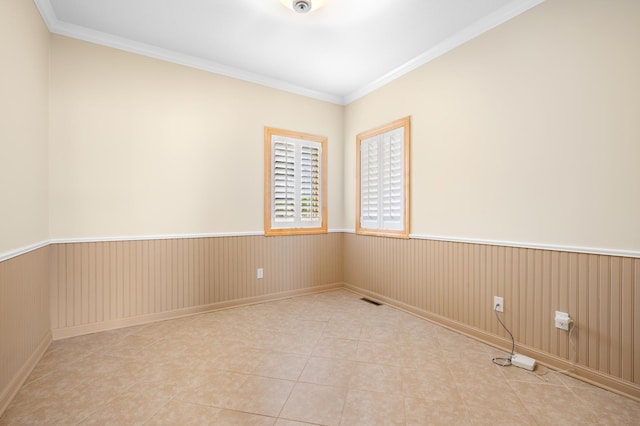 200 Michigan St Unit 1, Lake City, MN 55041 - spare room with light tile patterned flooring, visible vents, crown molding, and wainscoting