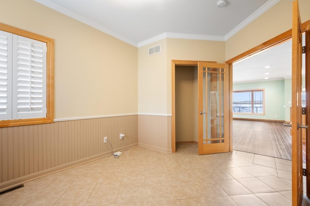 200 Michigan St Unit 1, Lake City, MN 55041 - tiled spare room featuring visible vents, crown molding, a wainscoted wall, and french doors