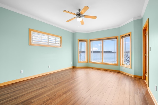 200 Michigan St Unit 1, Lake City, MN 55041 - spare room featuring wood finished floors, crown molding, baseboards, and ceiling fan