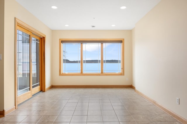 200 Michigan St Unit 1, Lake City, MN 55041 - empty room with baseboards, light tile patterned flooring, a water view, and recessed lighting
