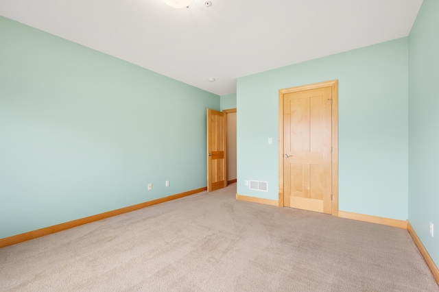 200 Michigan St Unit 1, Lake City, MN 55041 - unfurnished bedroom with baseboards, visible vents, and carpet