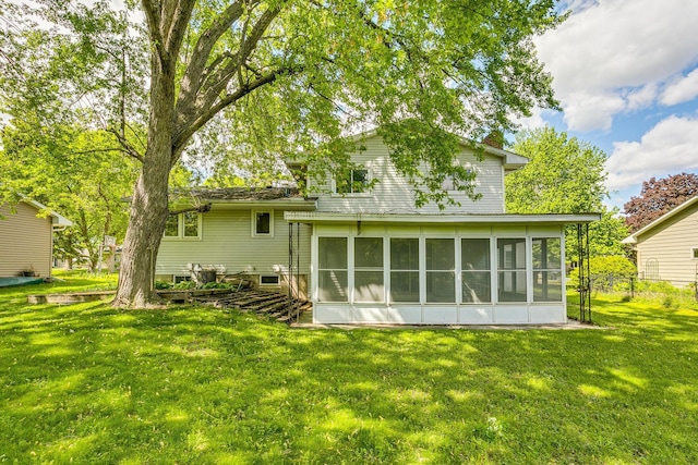980 Carlton Dr, Shoreview, MN 55126 - back of house featuring a sunroom and a lawn