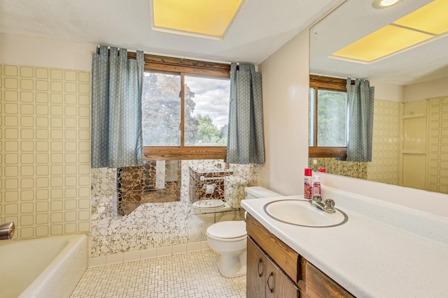 980 Carlton Dr, Shoreview, MN 55126 - full bathroom featuring toilet, healthy amount of natural light, vanity, and tile patterned flooring