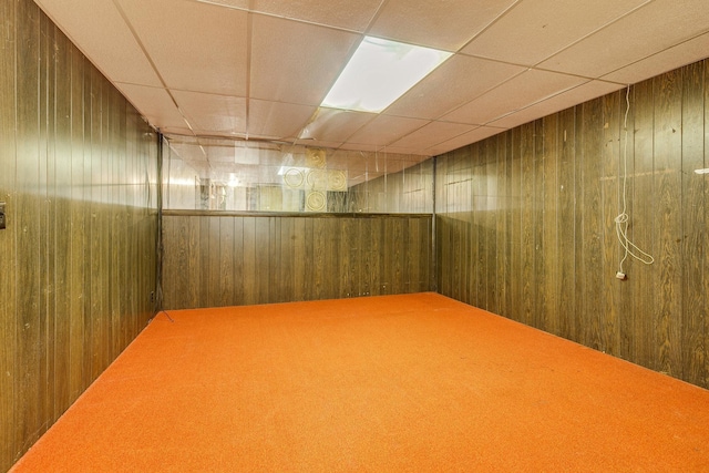 980 Carlton Dr, Shoreview, MN 55126 - unfurnished room featuring wooden walls, a drop ceiling, and carpet flooring