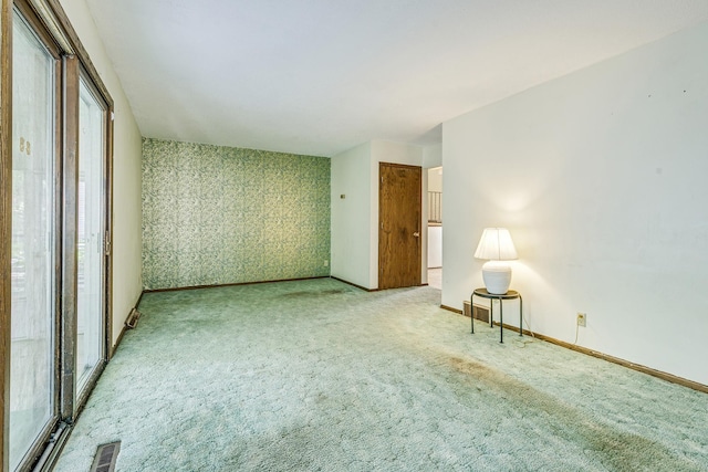 980 Carlton Dr, Shoreview, MN 55126 - carpeted empty room with baseboards and wallpapered walls