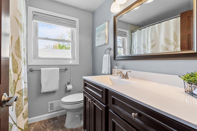 bathroom featuring marble look tiles, vanity, toilet, and baseboards