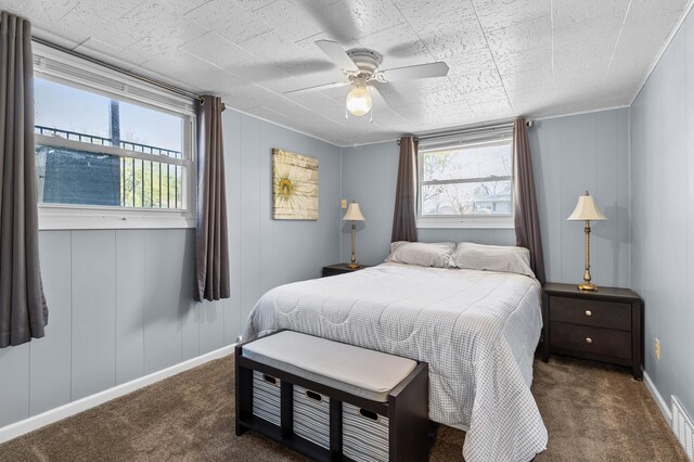 carpeted bedroom with a ceiling fan and baseboards