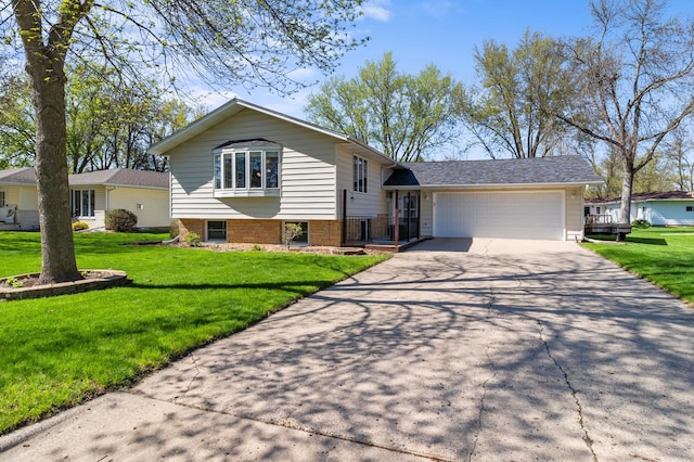 tri-level home with an attached garage, driveway, and a front lawn