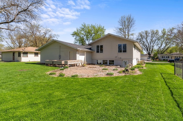 back of house with a yard and an attached garage