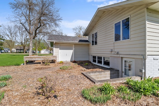 view of side of home featuring roof with shingles