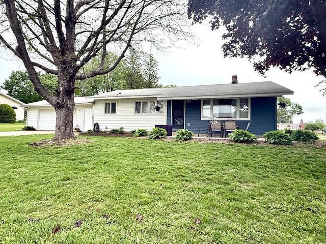 106 Mcphail Ave N, Caledonia, MN 55921 - single story home featuring a front yard, covered porch, a chimney, driveway, and an attached garage