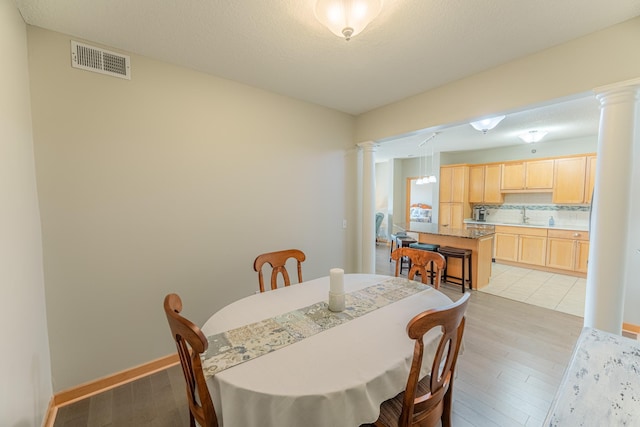 630 Main St N Unit 308, Stillwater, MN 55082 - dining area featuring ornate columns, visible vents, and light wood finished floors