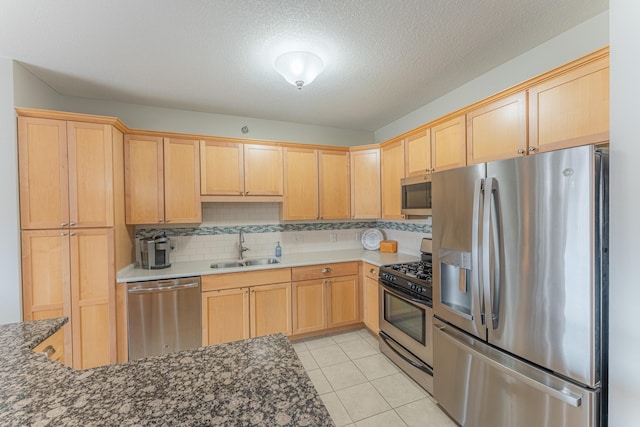 630 Main St N Unit 308, Stillwater, MN 55082 - kitchen with a sink, appliances with stainless steel finishes, backsplash, and light brown cabinetry