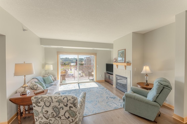 630 Main St N Unit 308, Stillwater, MN 55082 - living room featuring baseboards, wood finished floors, and a fireplace