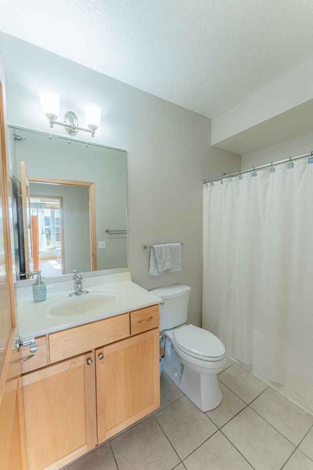 630 Main St N Unit 308, Stillwater, MN 55082 - bathroom with vanity, tile patterned flooring, toilet, and a textured ceiling