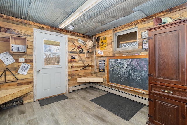 interior space featuring light wood finished floors and wood walls