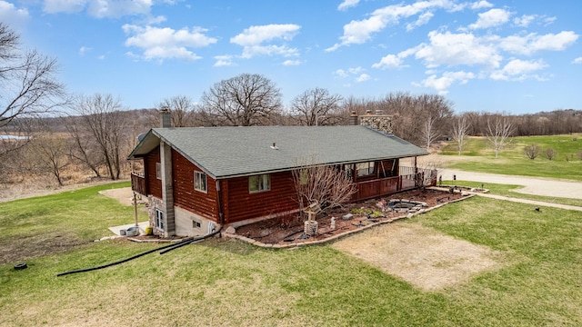 view of property exterior featuring a porch, a lawn, a chimney, and roof with shingles