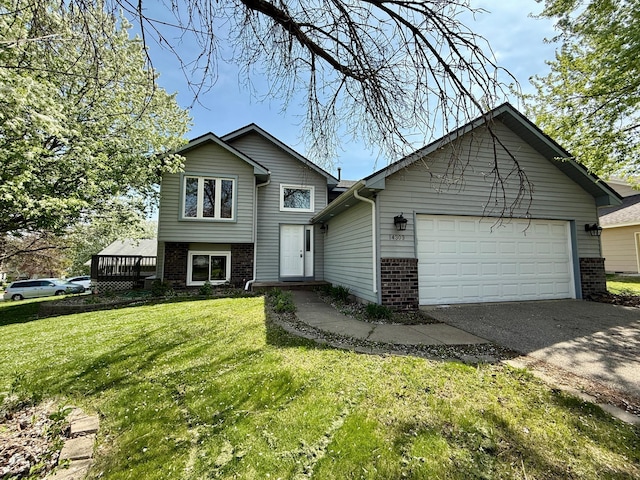 14303 Utica Ave, Savage, MN 55378 - split level home with brick siding, driveway, a garage, and a front yard