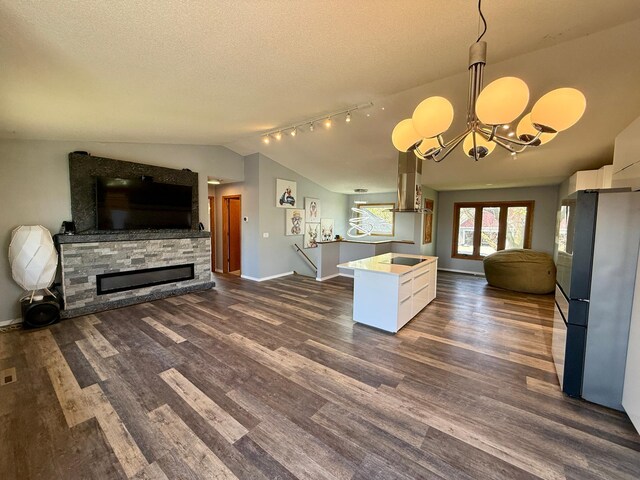 14303 Utica Ave, Savage, MN 55378 - kitchen featuring open floor plan, freestanding refrigerator, white cabinets, vaulted ceiling, and dark wood-type flooring