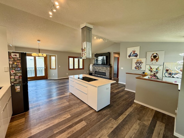 14303 Utica Ave, Savage, MN 55378 - kitchen featuring black appliances, track lighting, open floor plan, dark wood-style flooring, and a textured ceiling