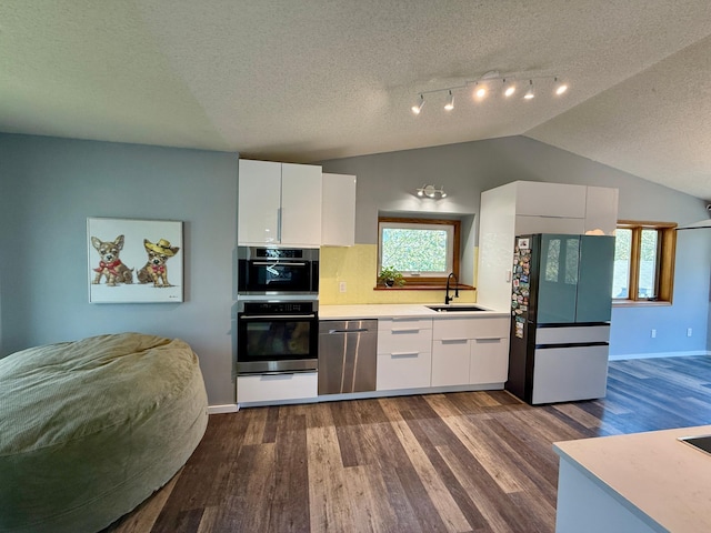 14303 Utica Ave, Savage, MN 55378 - kitchen with dishwasher, freestanding refrigerator, a sink, a textured ceiling, and dark wood finished floors