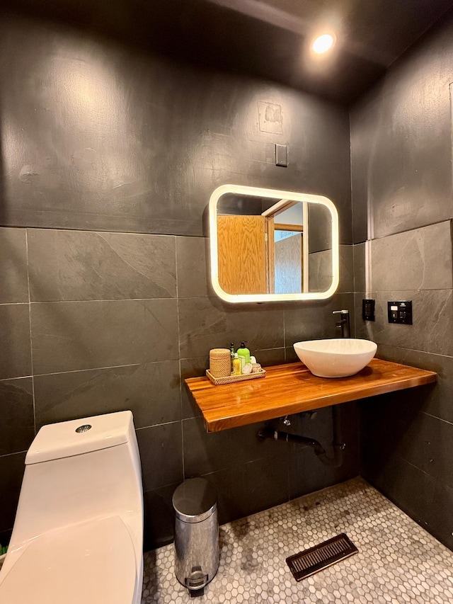14303 Utica Ave, Savage, MN 55378 - bathroom with tile walls, a sink, and tile patterned floors