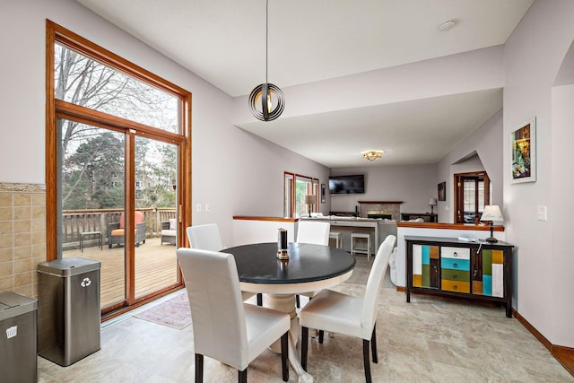 dining room with plenty of natural light and a fireplace