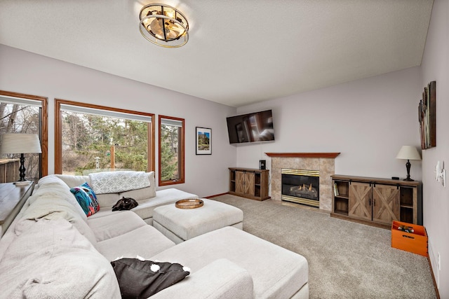 carpeted living room featuring baseboards and a premium fireplace