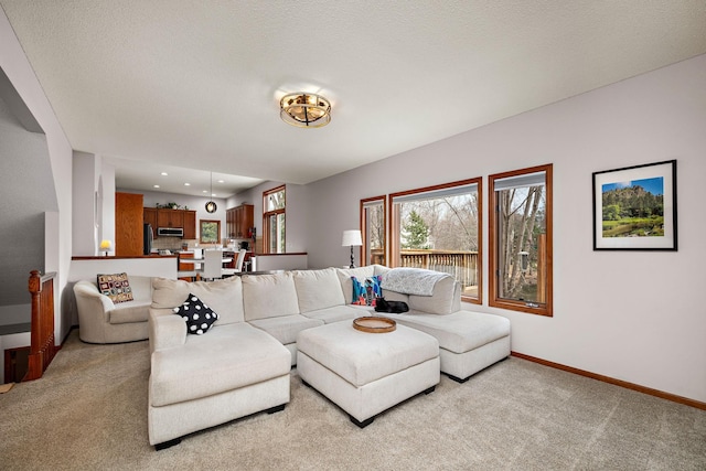living area with light carpet, baseboards, and recessed lighting