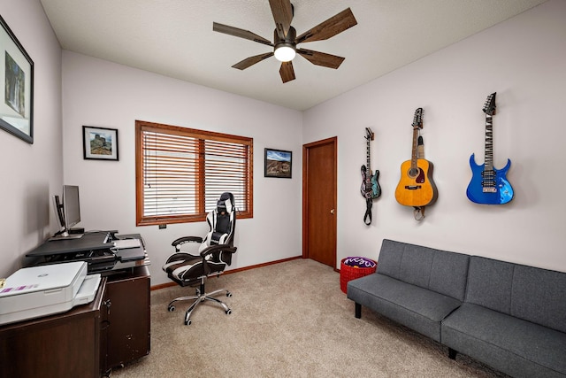 office area featuring light colored carpet, baseboards, and a ceiling fan