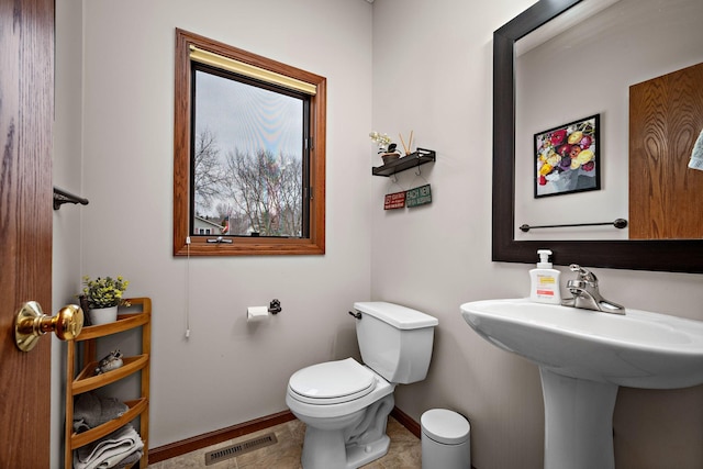 bathroom with toilet, baseboards, and visible vents