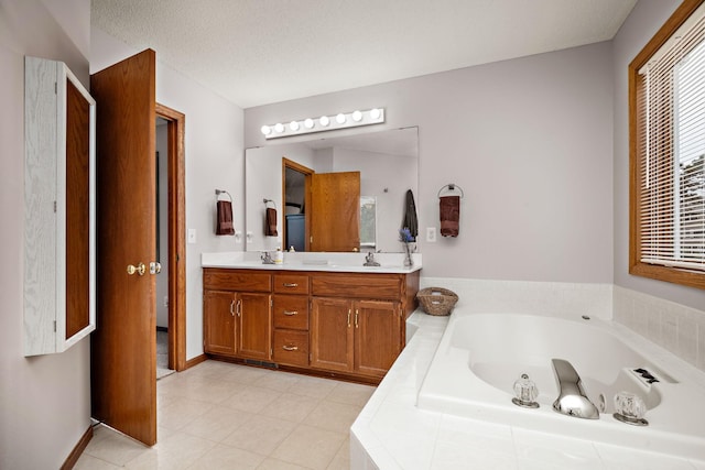 full bath featuring baseboards, double vanity, tile patterned floors, a bath, and a sink