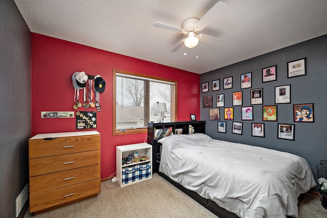 bedroom with a textured ceiling, ceiling fan, visible vents, and carpet floors