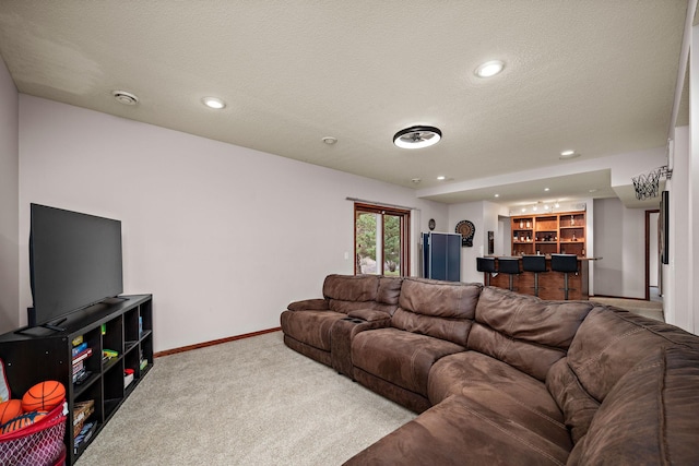 carpeted living room with a textured ceiling, recessed lighting, baseboards, and bar