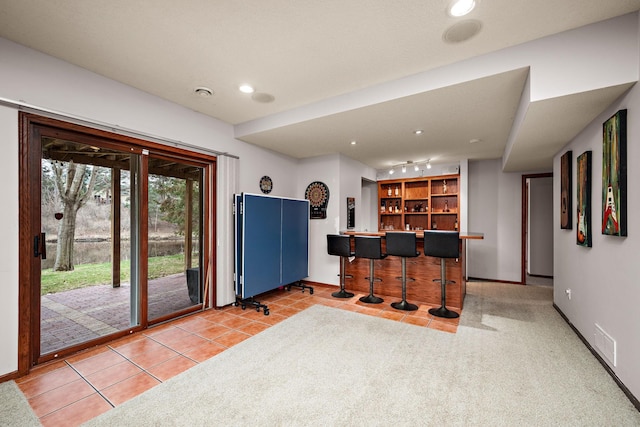 interior space featuring indoor bar, visible vents, baseboards, and recessed lighting